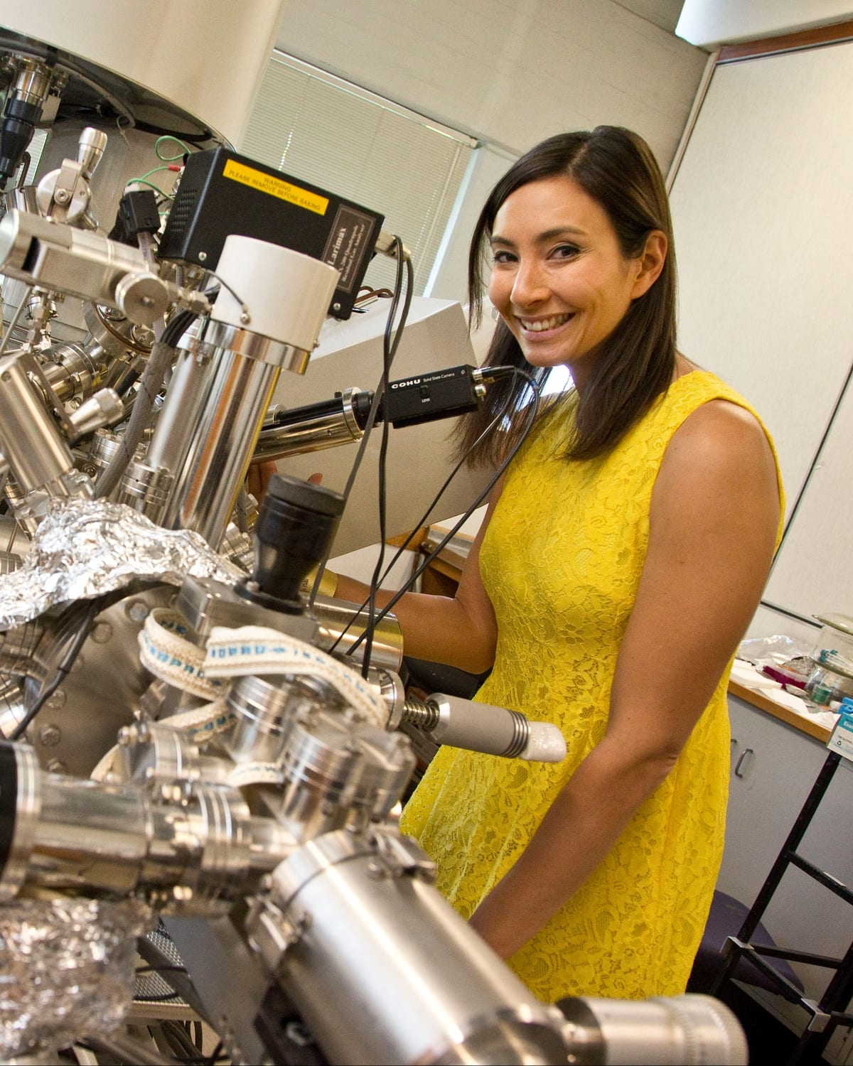 Dr Michelle Dickinson working at a scanning probe instrument in a materials laboratory